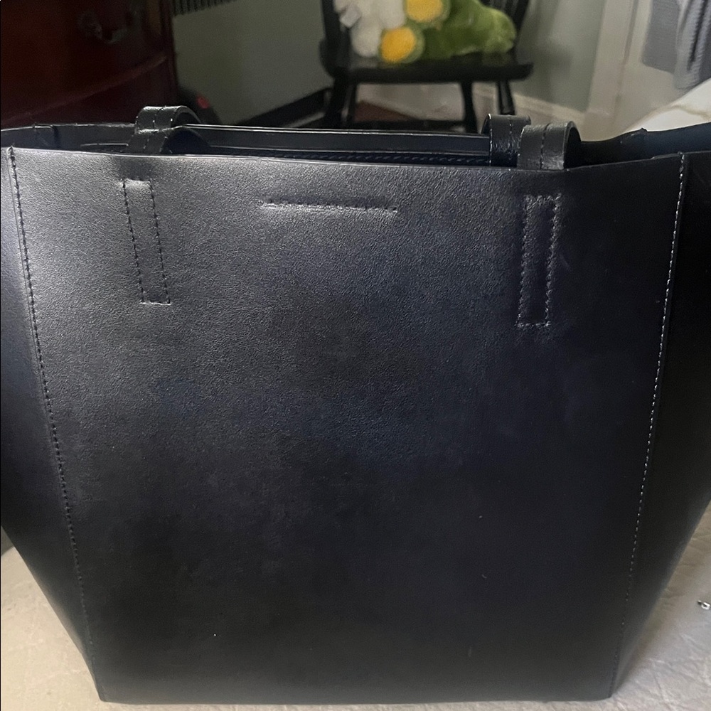 Sleek Black Tote Bag.  Leather.  Excellent condition.  Inside zippered pocket